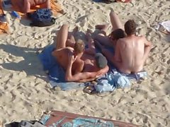 Group of guys having sex on the beach