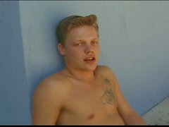 Tattooed gay twink masturbates by the pool